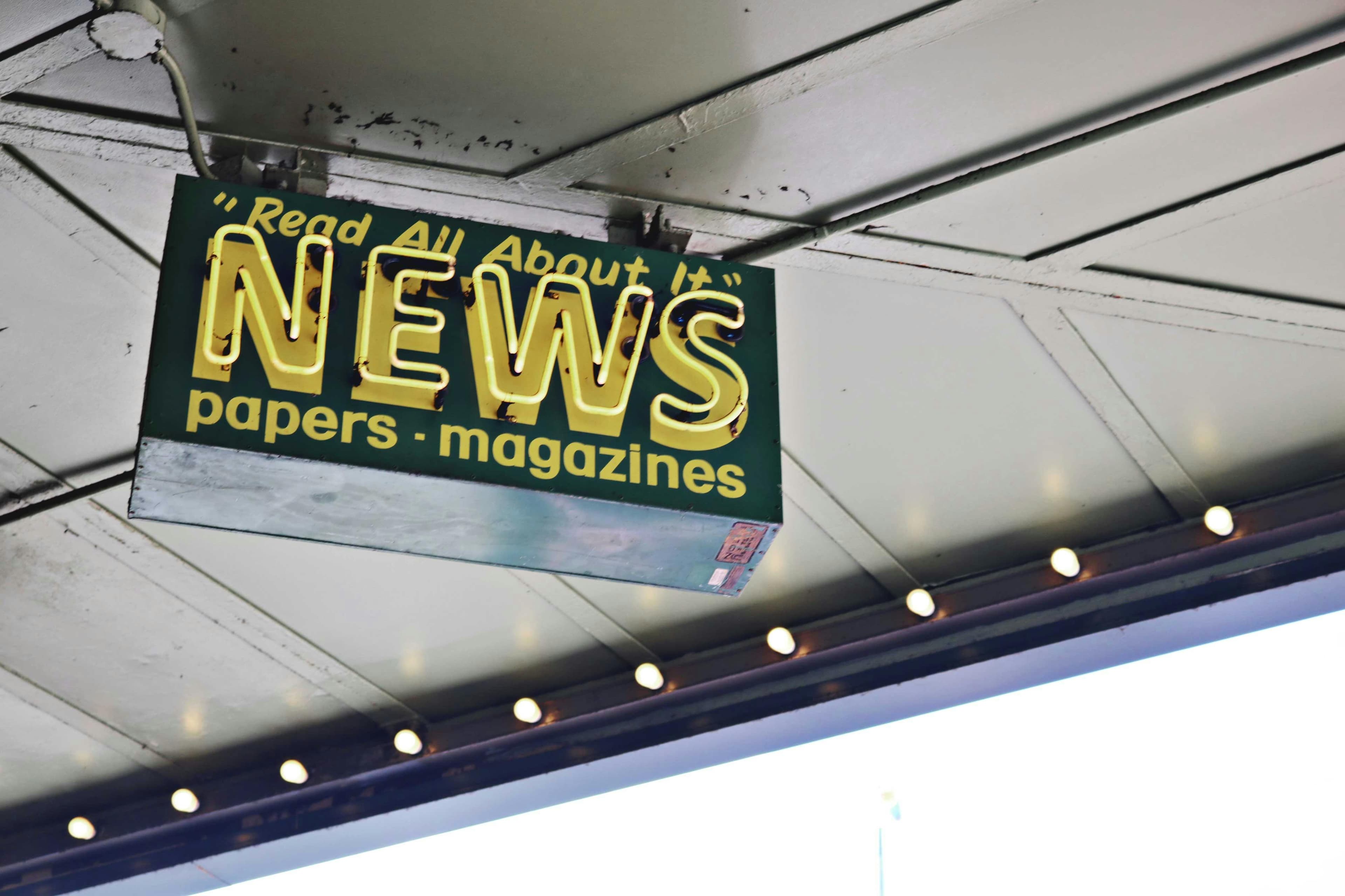 A shop sign advertising newspapers and magazines